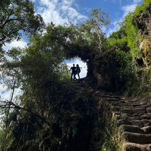 Hikers trekking in the Andes mountains near Cusco with scenic high-altitude landscapes.