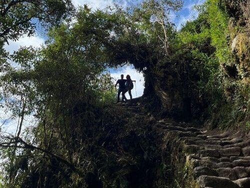 Hikers trekking in the Andes mountains near Cusco with scenic high-altitude landscapes.