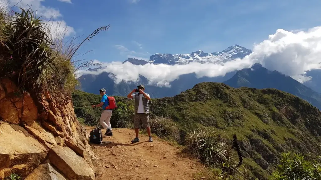 Travelers enjoying a peresonalized journey in the Andes near Cusco with show-capped mountains