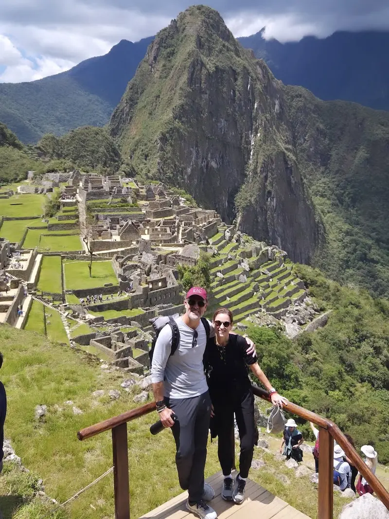 Couple visiting Machu Picchu in Peru with mountains in the background