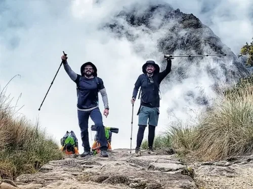 Travelers hiking the Inca Trail to Machu Picchu through the Peruvian Andes