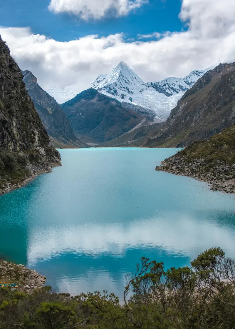Huascaran mountain reflected in a turquoise lagoon in Peru