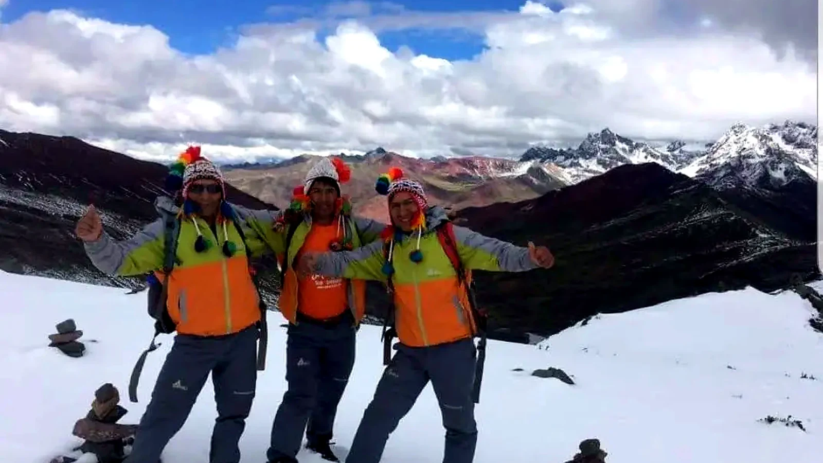 Three Santu guides wearing colorful Andean hats on the Ausangate trek